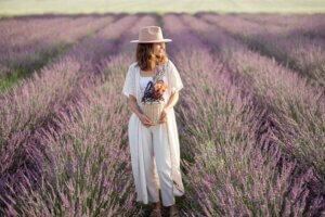 Woman standing in silence in front of field of lavender..