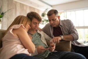 Creating a Safe Environment for a Crucial Conversation - family sitting close together in living room